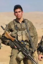 IDF combat soldiers killed in action, often in desert or training/field settings. Based on the filename and typical posts, it likely depicts Sergeant Idan Fuchs (or Idan Fooks), a 19-year-old soldier from Petah Tikva in the 77th Battalion of the 7th Armored Brigade, killed in southern Lebanon.